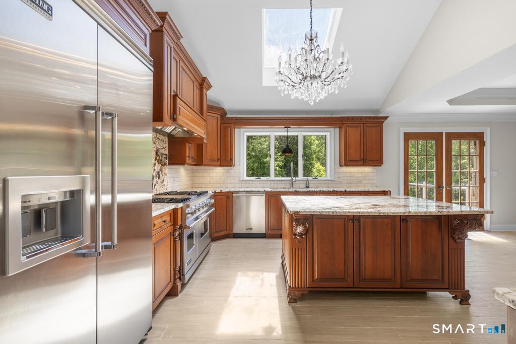 49 Partridge Lane Middletown, CT 06457 - Photo 13 of 39 a kitchen with stainless steel appliances granite countertop a sink a stove and a refrigerator