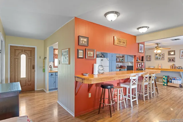 a dining room with furniture and wooden floor