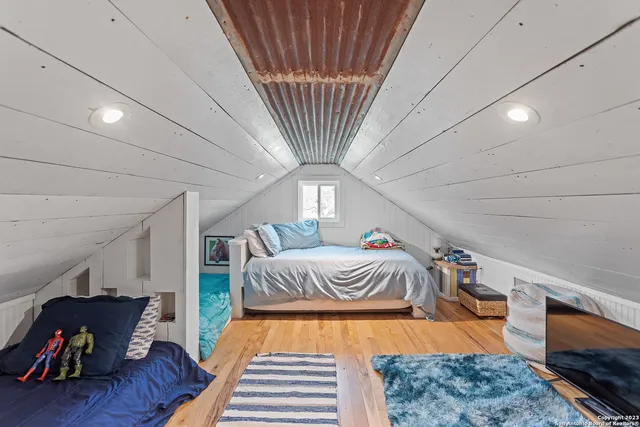 a bedroom with furniture and a wooden floor