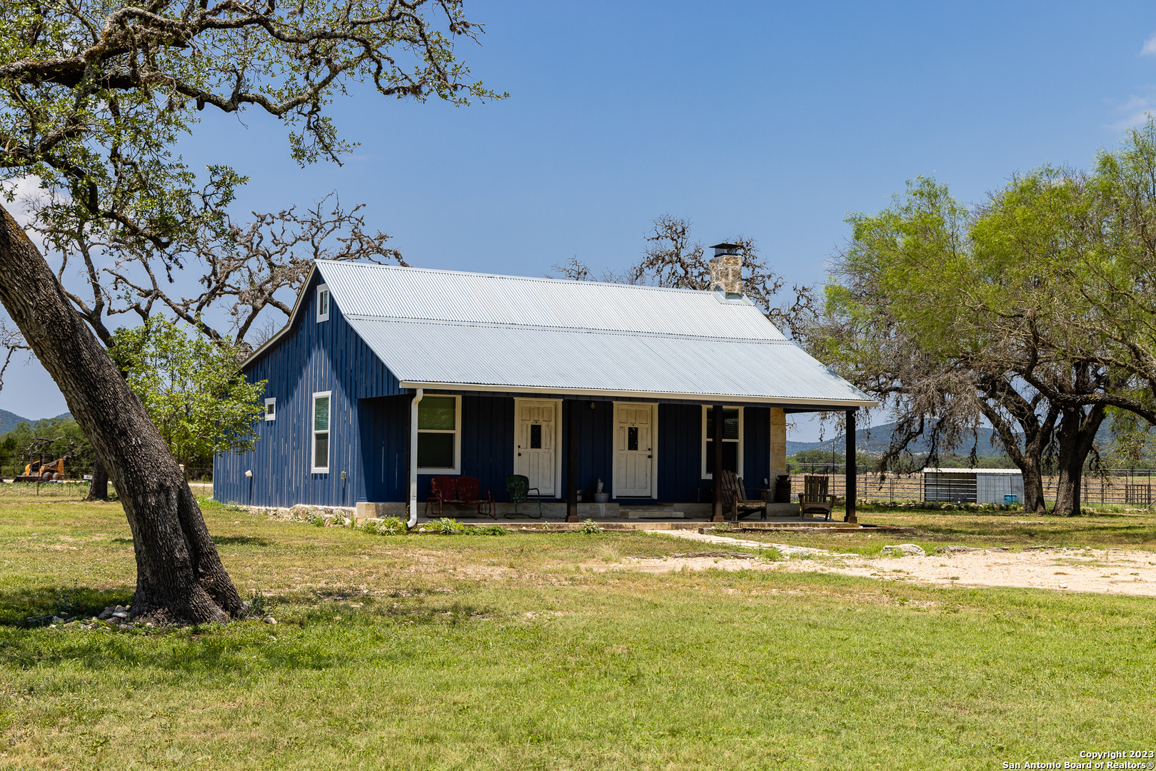 5374 County Road 111 Utopia, TX 78884 - Photo 3 of 24 a view of a white house with a large tree
