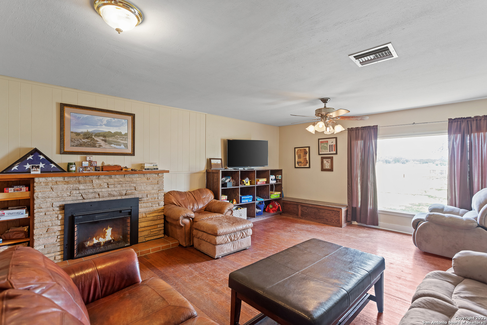 5374 County Road 111 Utopia, TX 78884 - Photo 10 of 24 a living room with furniture a flat screen tv and a fireplace