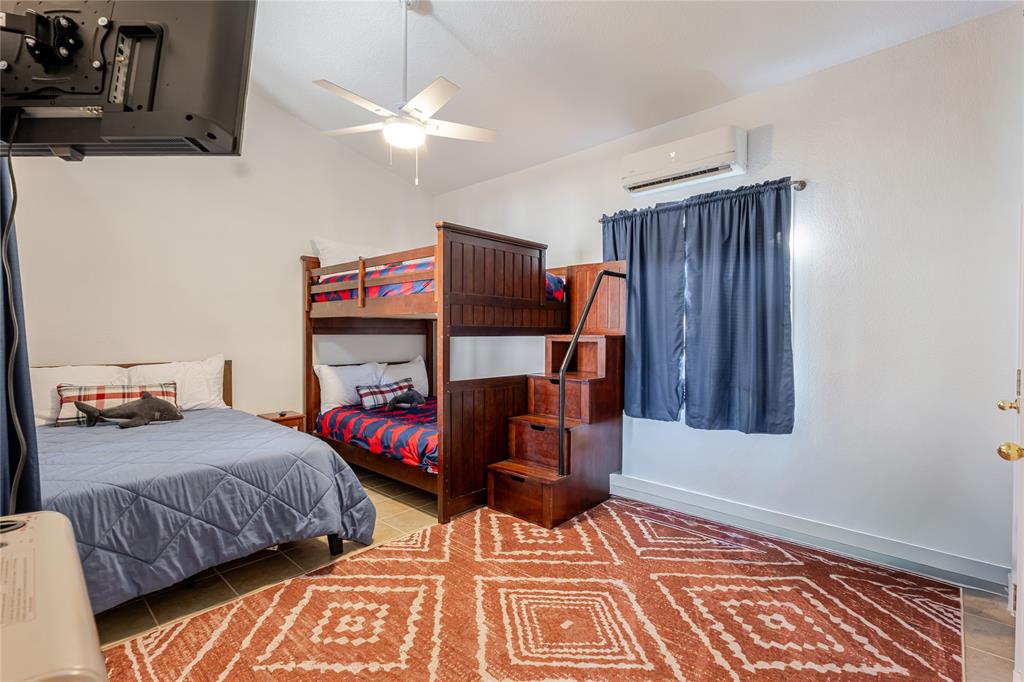 1601 Forum Circle, Unit 156 Graford, TX 76449 - Photo 13 of 28 a bedroom with bed and wooden floor
