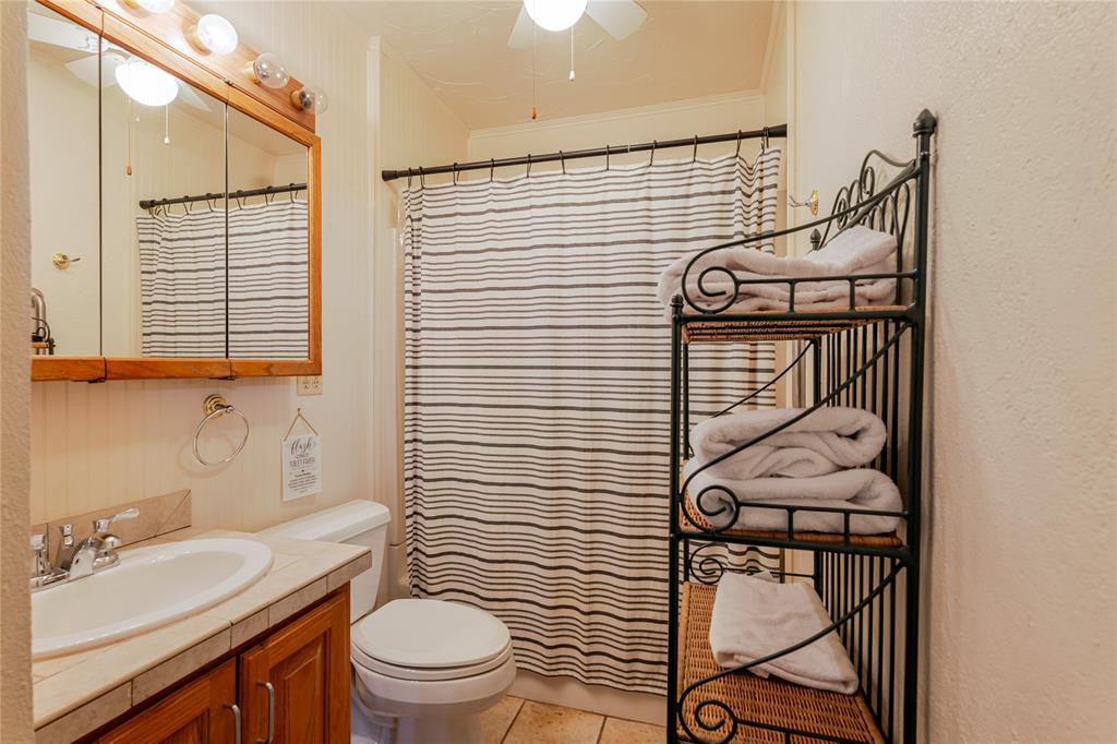1601 Forum Circle, Unit 156 Graford, TX 76449 - Photo 14 of 28 a bathroom with a sink toilet and shower