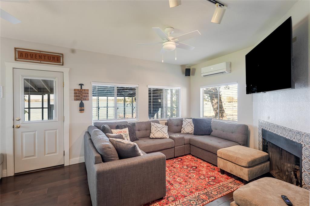 1601 Forum Circle, Unit 156 Graford, TX 76449 - Photo 3 of 28 a living room with furniture a flat screen tv and a window