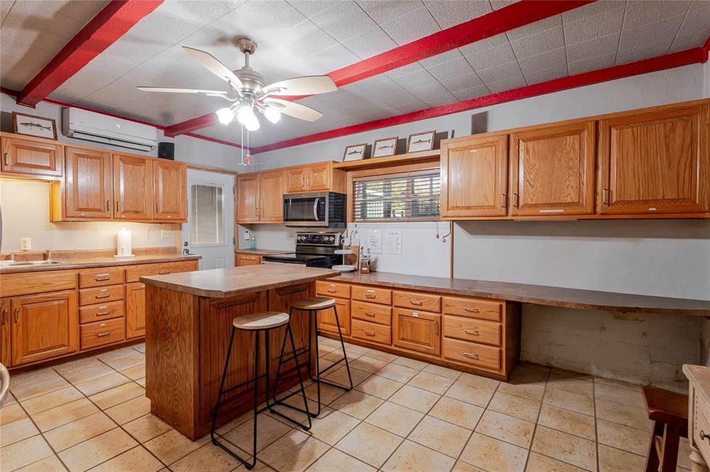 1601 Forum Circle, Unit 156 Graford, TX 76449 - Photo 8 of 28 a kitchen with stainless steel appliances granite countertop a sink and cabinets