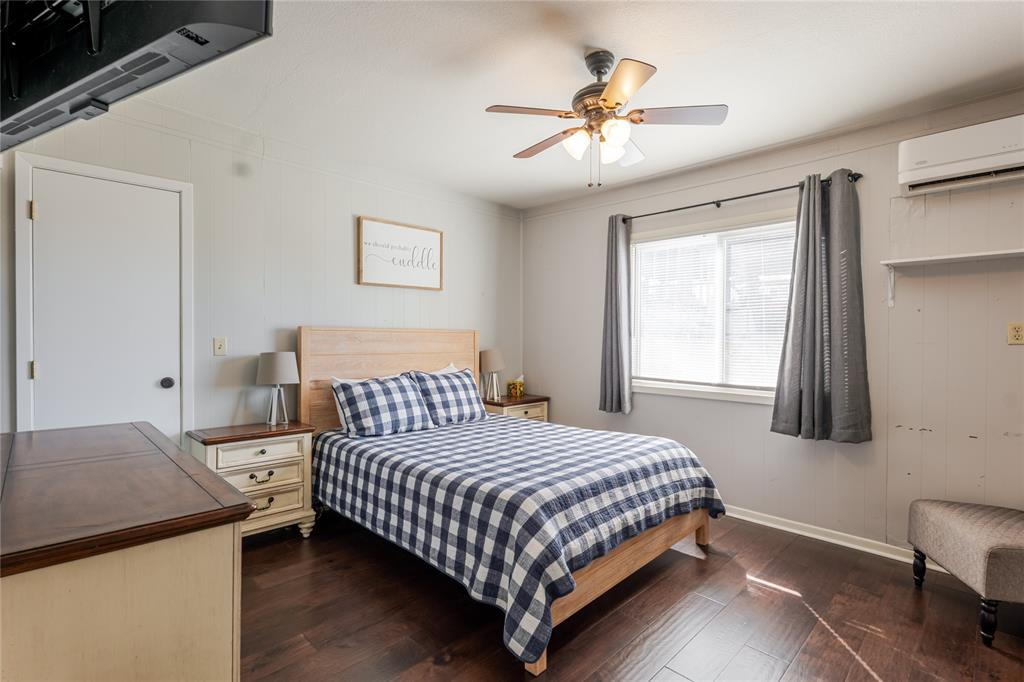 1601 Forum Circle, Unit 156 Graford, TX 76449 - Photo 9 of 28 a bedroom with a bed and a chandelier