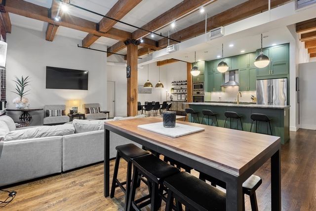 a view of a dining room with furniture and wooden floor