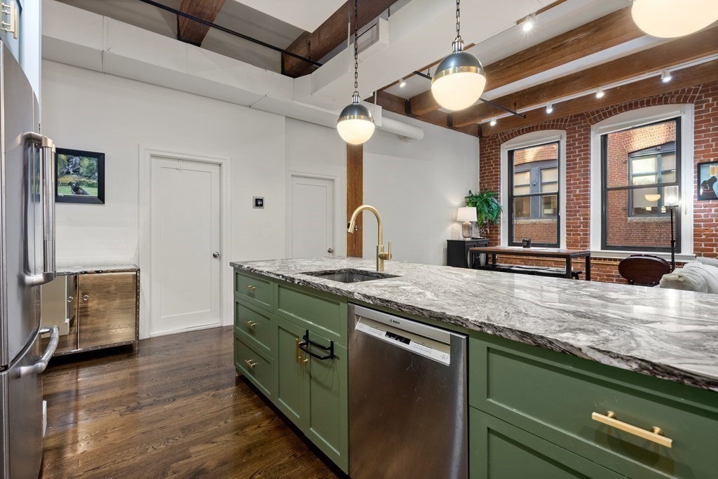 15 Sleeper Street, Unit 302 Boston, MA 02210 - Photo 16 of 35 a kitchen with stainless steel appliances granite countertop a sink and a stove
