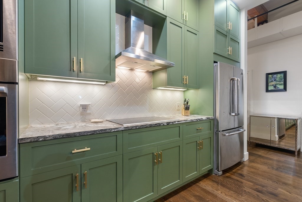 15 Sleeper Street, Unit 302 Boston, MA 02210 - Photo 17 of 35 a bathroom with a granite countertop sink and a mirror