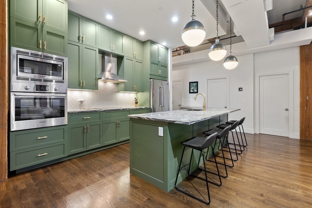 15 Sleeper Street, Unit 302 Boston, MA 02210 - Photo 18 of 35 a kitchen with a table and chairs in it