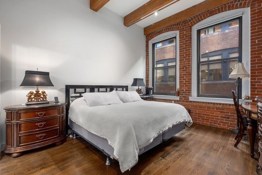 15 Sleeper Street, Unit 302 Boston, MA 02210 - Photo 19 of 35 a bedroom with a bed and large windows