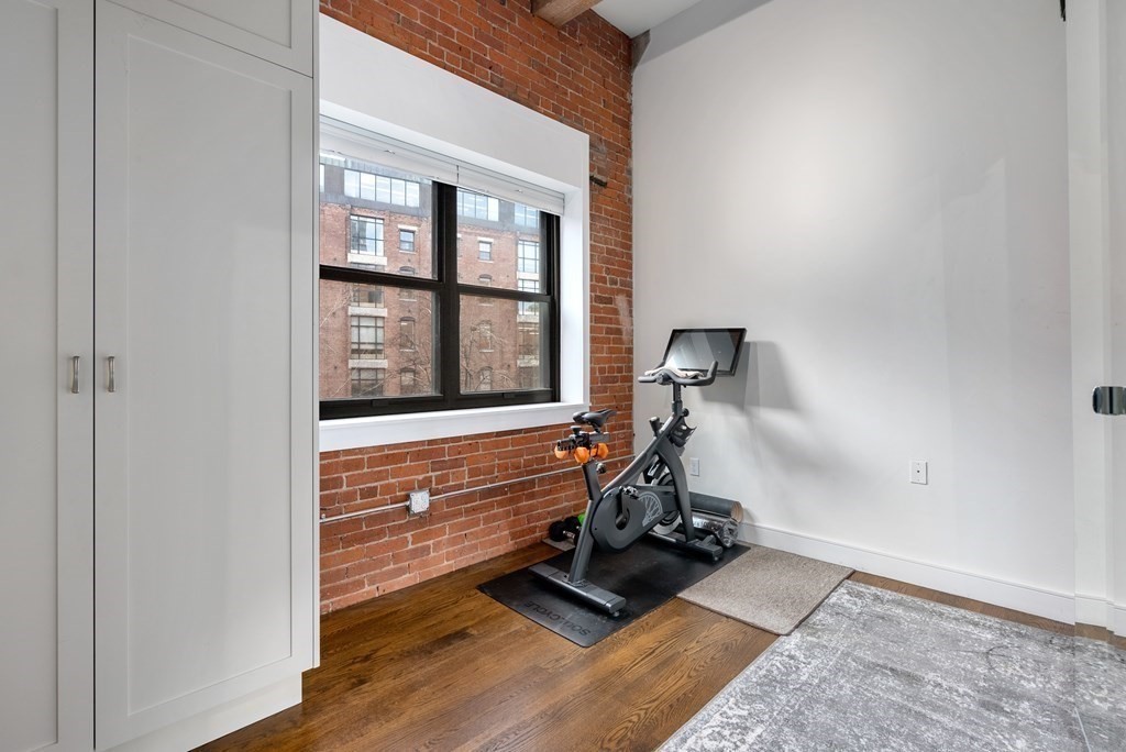 15 Sleeper Street, Unit 302 Boston, MA 02210 - Photo 25 of 35 a view of a room with gym equipment and windows