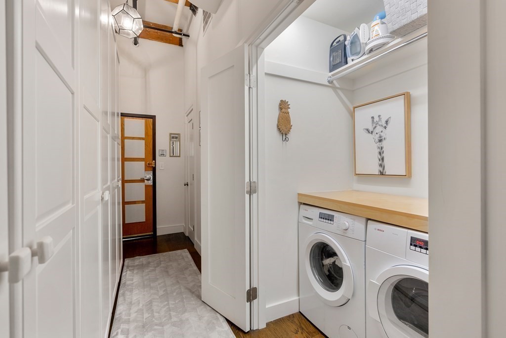 15 Sleeper Street, Unit 302 Boston, MA 02210 - Photo 26 of 35 a view of a hallway with washer and dryer