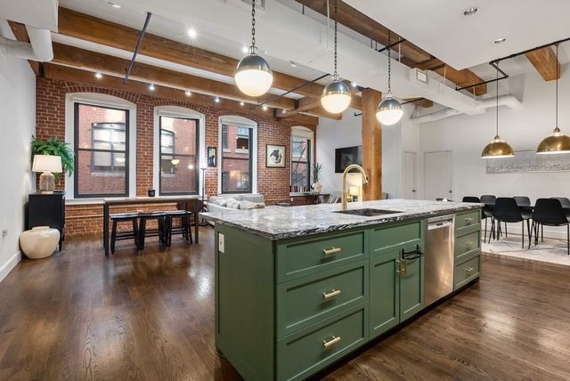 a kitchen with sink and cabinets