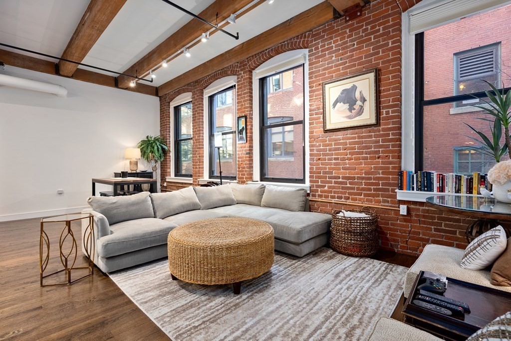 15 Sleeper Street, Unit 302 Boston, MA 02210 - Photo 6 of 35 a living room with furniture and a window