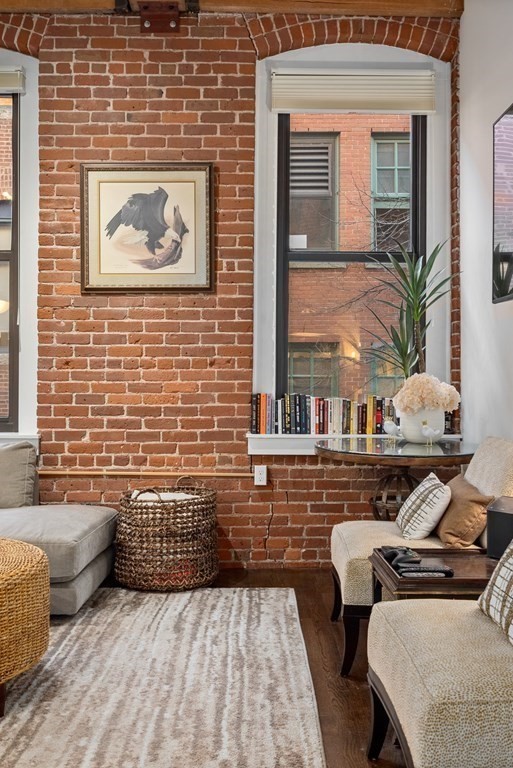 15 Sleeper Street, Unit 302 Boston, MA 02210 - Photo 7 of 35 a view of a patio with couches chairs and wooden floor