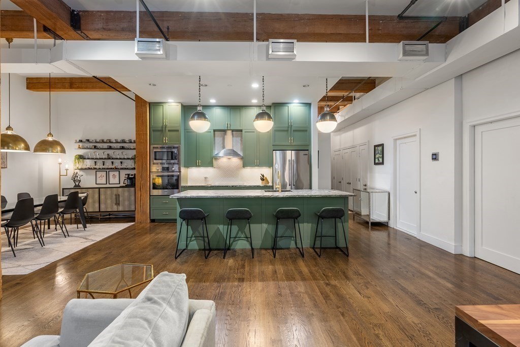15 Sleeper Street, Unit 302 Boston, MA 02210 - Photo 9 of 35 a view of a dining room with furniture window and wooden floor