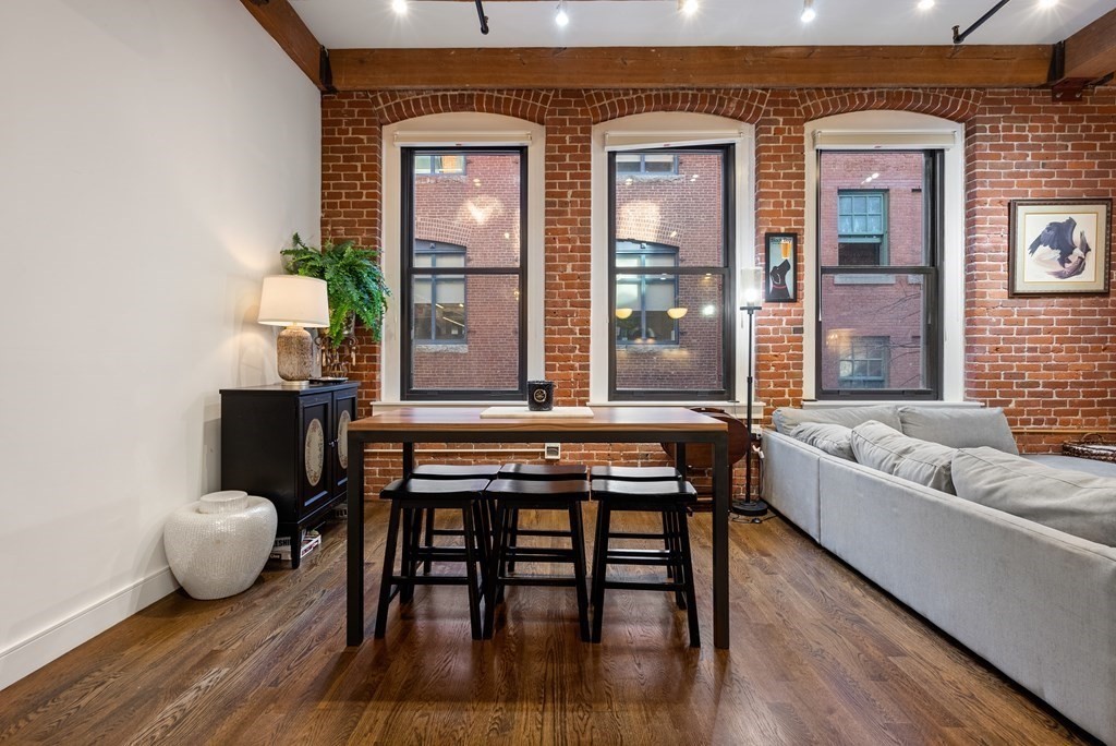 15 Sleeper Street, Unit 302 Boston, MA 02210 - Photo 10 of 35 a living room with furniture and wooden floor