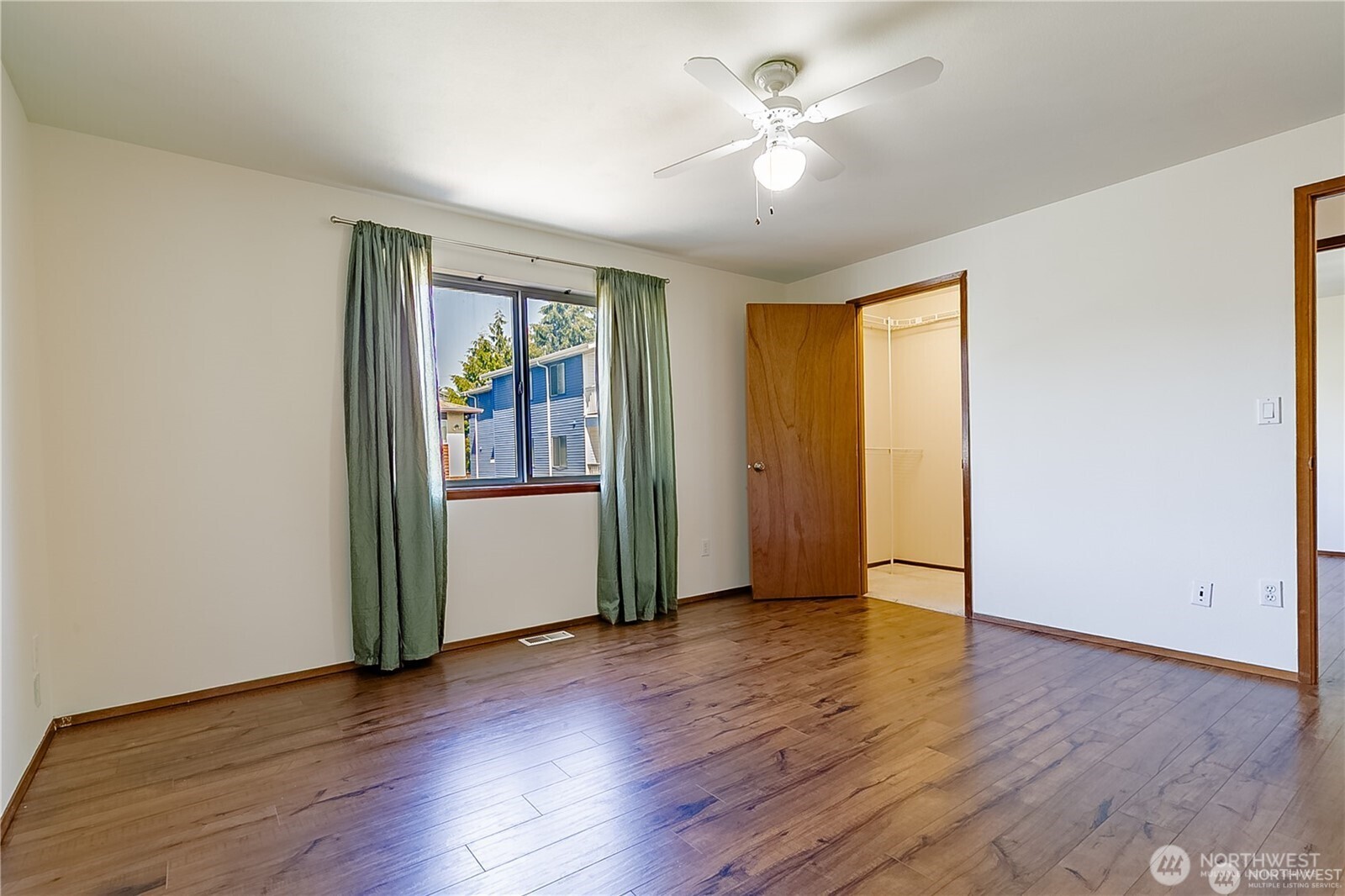 512 North 104th Street Seattle, WA 98133 - Photo 12 of 15 an empty room with wooden floor and a ceiling fan