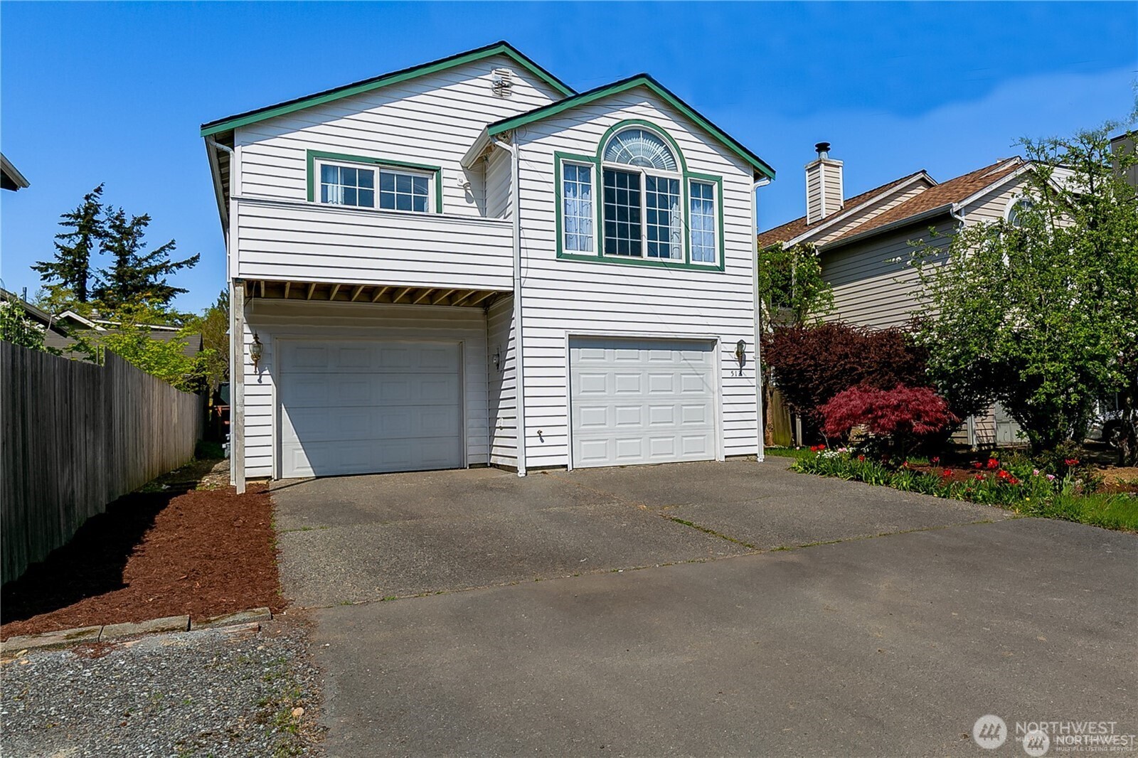 512 North 104th Street Seattle, WA 98133 - Photo 2 of 15 a front view of a house with a yard and garage