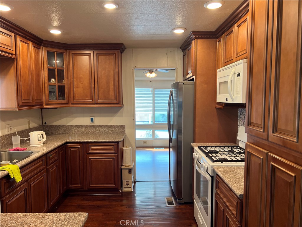 1001 West Lambert Road, Unit 284 La Habra, CA 90631 - Photo 16 of 28 a kitchen with stainless steel appliances granite countertop a stove a sink and a refrigerator