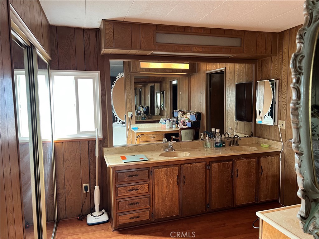 1001 West Lambert Road, Unit 284 La Habra, CA 90631 - Photo 17 of 28 a bathroom with a double vanity sink and a mirror
