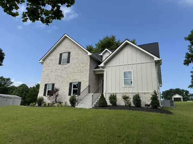 a front view of a house with a yard and garage