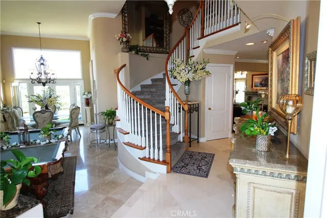 a dining room with furniture a potted plant and a chandelier
