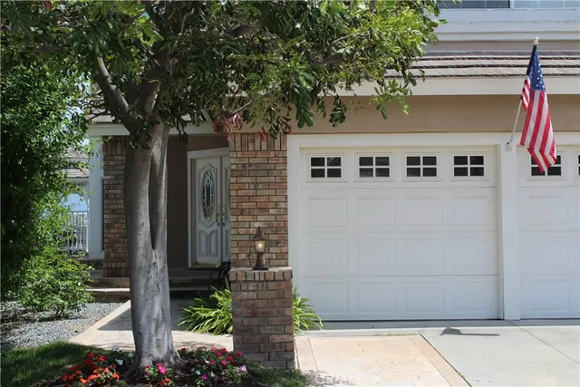 a front view of a house with plants