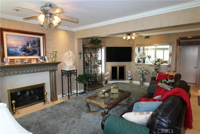 a living room with furniture a fireplace and a flat screen tv
