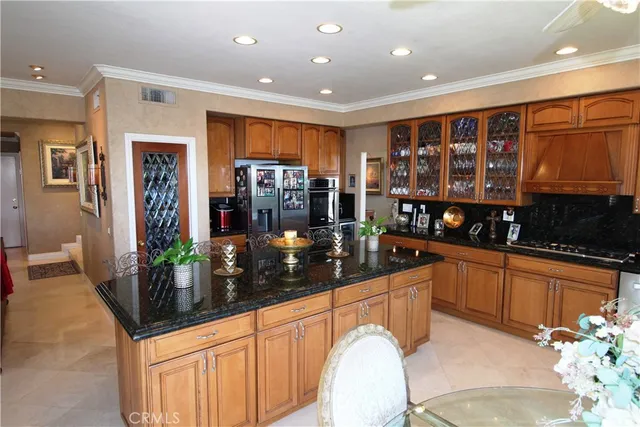 a kitchen with stainless steel appliances granite countertop a sink and cabinets