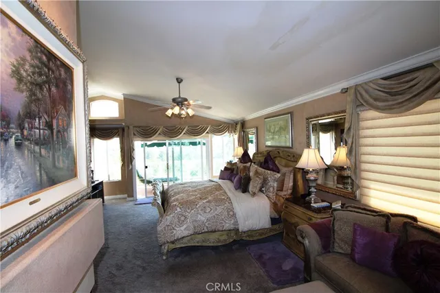 a bedroom with bed couch and window