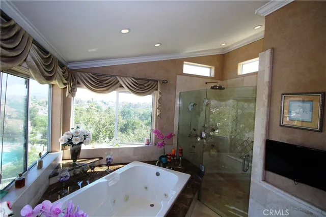 a bathroom with a bathtub a sink and a large mirror