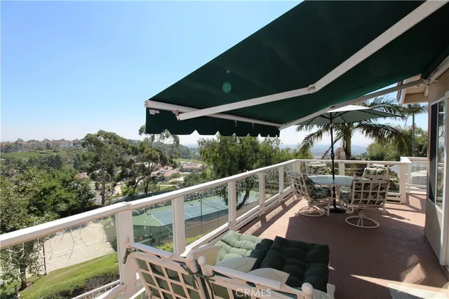 a view of a balcony with chairs