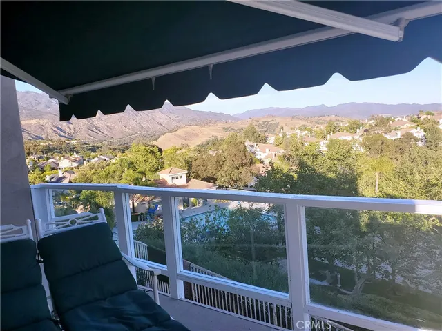 a view of a two chairs in the balcony