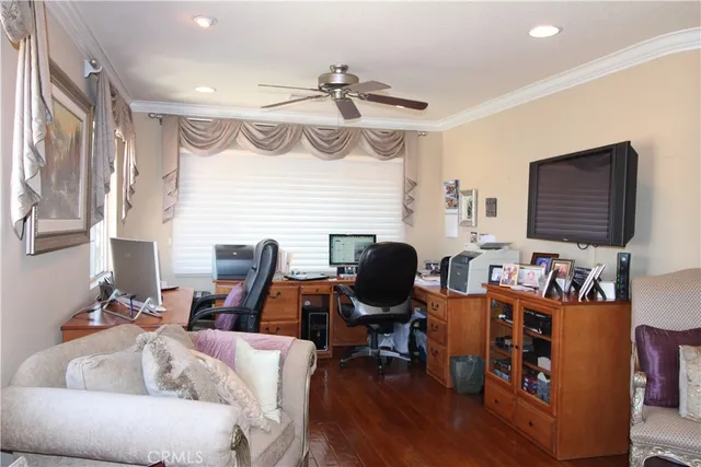 a living room with furniture a flat screen tv and gym equipment