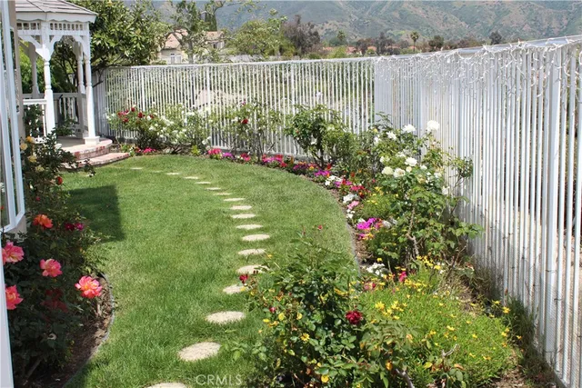 a view of a statue in a yard next to a lake