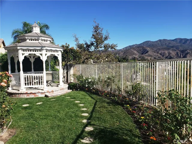 a view of a house with a small yard and a garden