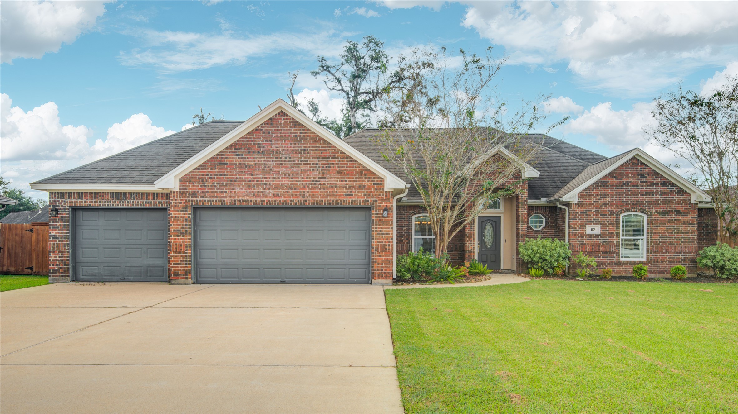 57 Red Maple Court Lake Jackson, TX 77566 - Photo 1 of 44 a front view of a house with a yard and garage