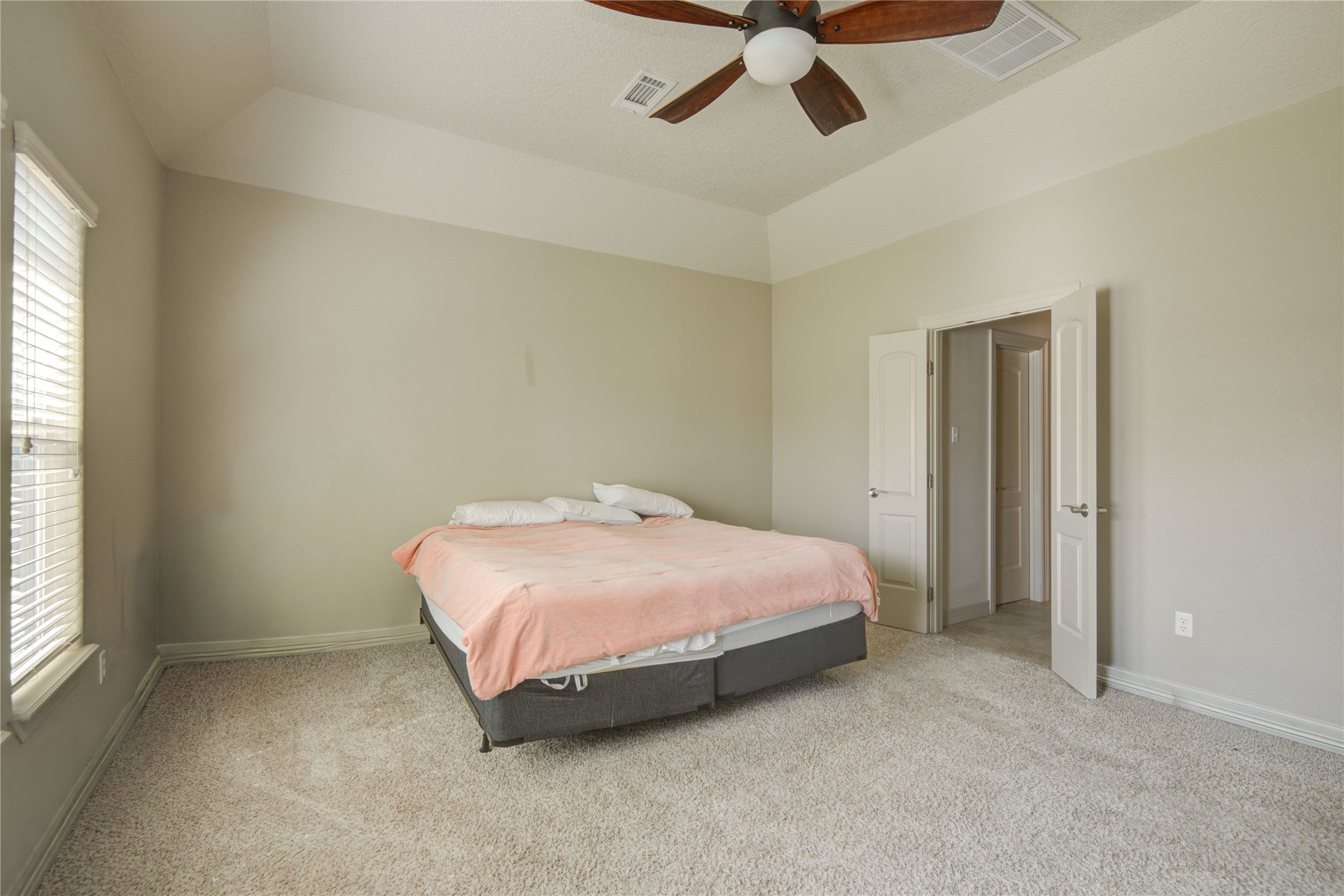 57 Red Maple Court Lake Jackson, TX 77566 - Photo 15 of 44 a bedroom with a bed and window