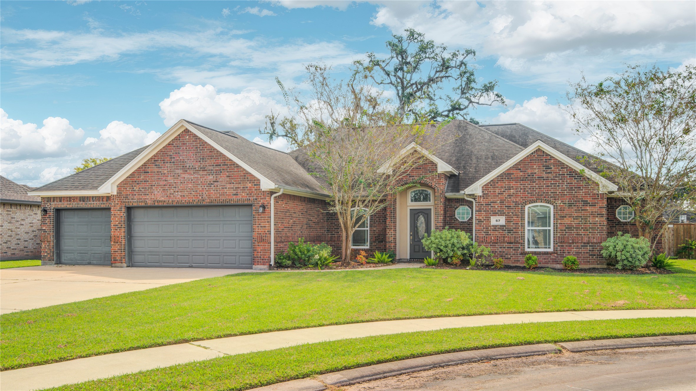 57 Red Maple Court Lake Jackson, TX 77566 - Photo 2 of 44 a front view of a house with a garden and plants