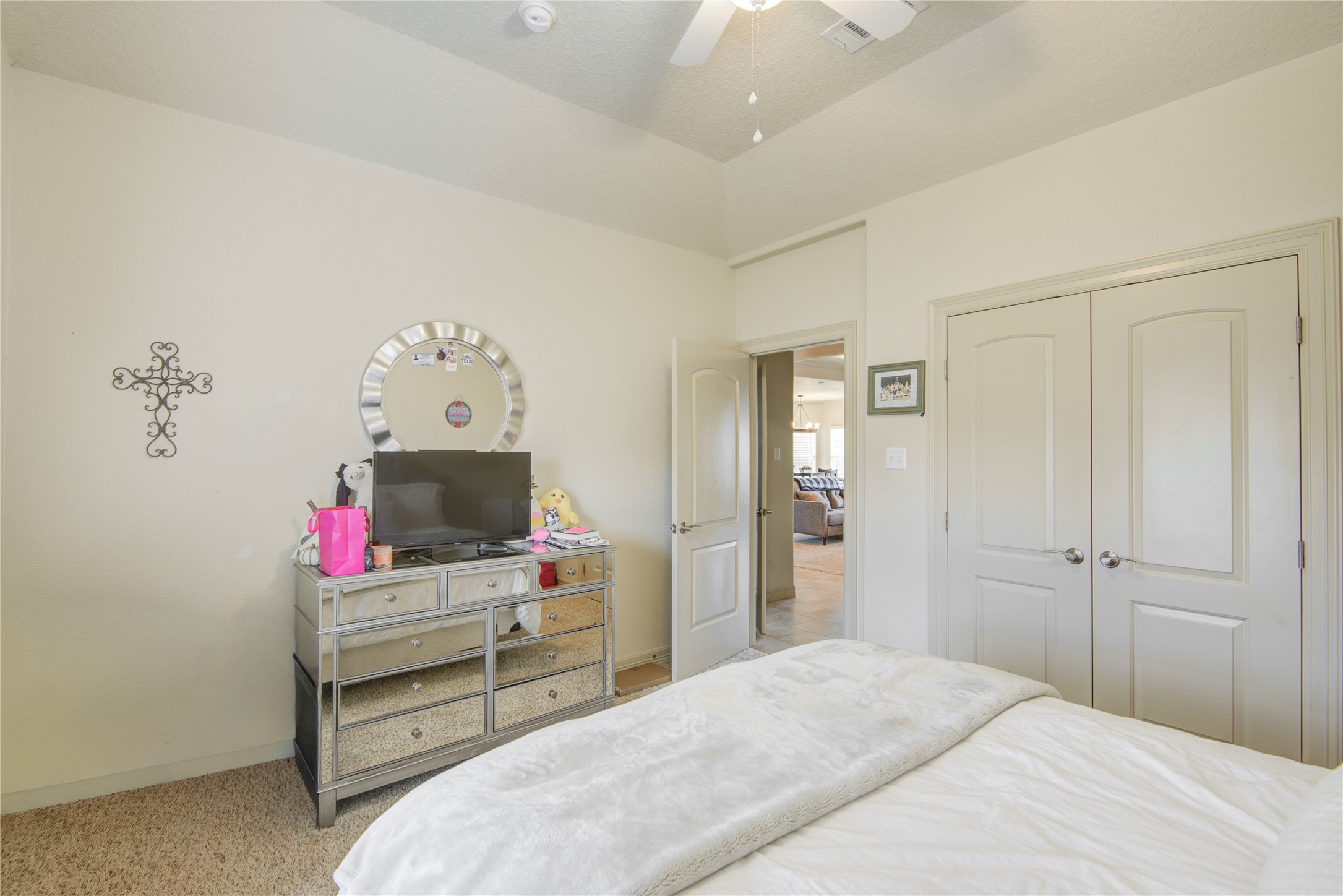 57 Red Maple Court Lake Jackson, TX 77566 - Photo 22 of 44 a bedroom with a bed and a flat tv screen on the dresser