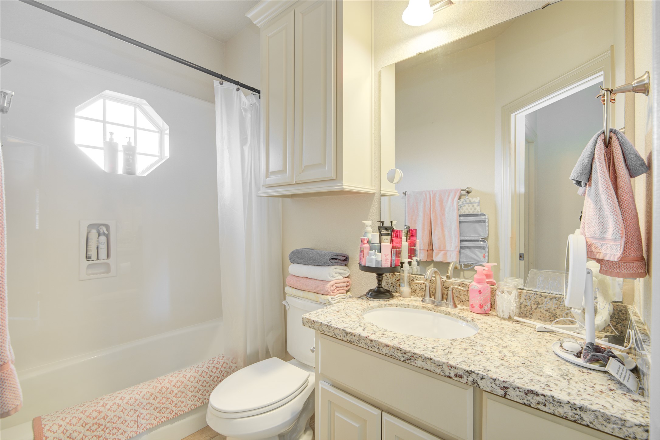 57 Red Maple Court Lake Jackson, TX 77566 - Photo 23 of 44 a bathroom with a granite countertop sink mirror vanity bathtub and a toilet