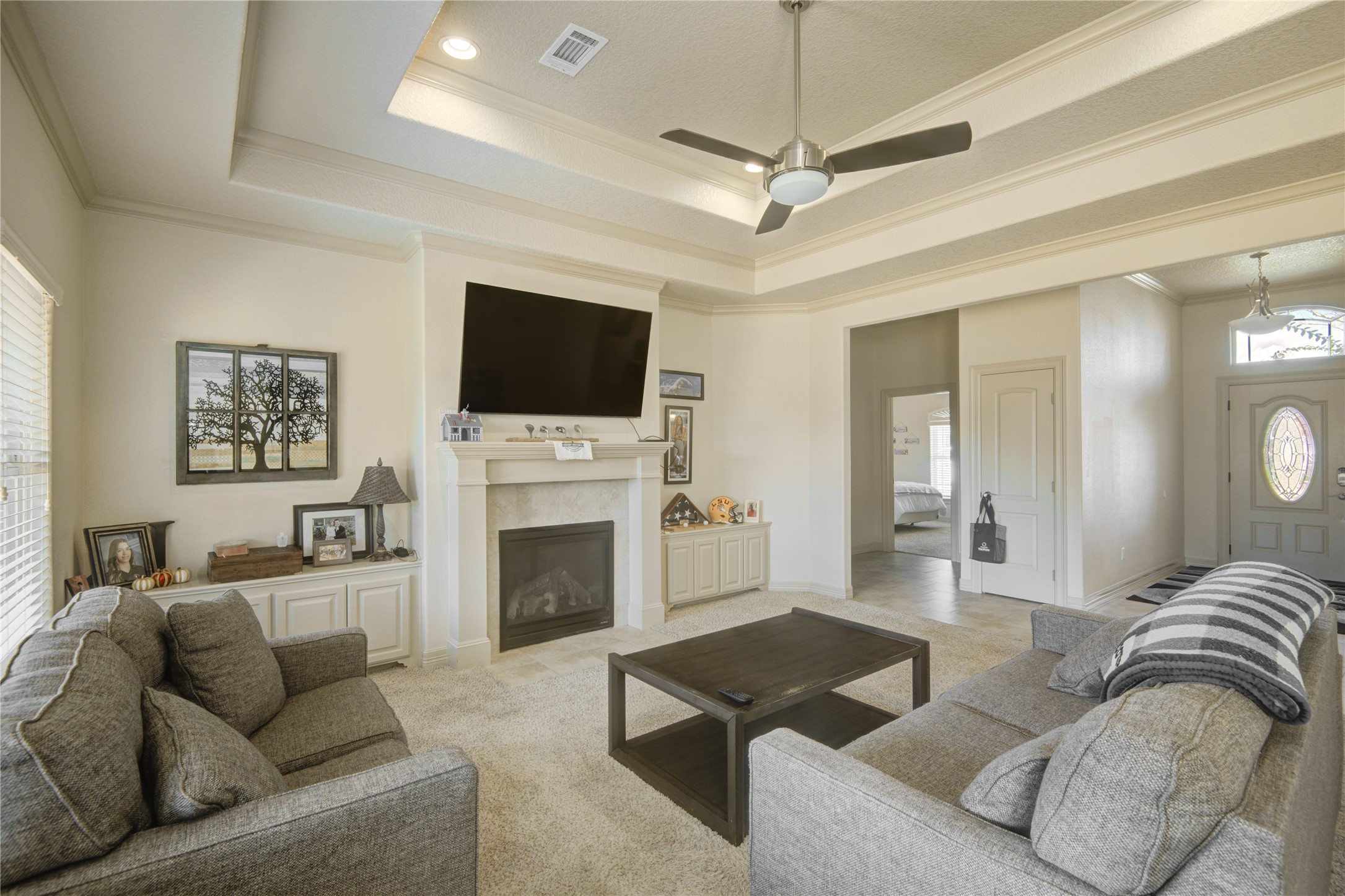 57 Red Maple Court Lake Jackson, TX 77566 - Photo 29 of 44 a living room with furniture a flat screen tv and a fireplace