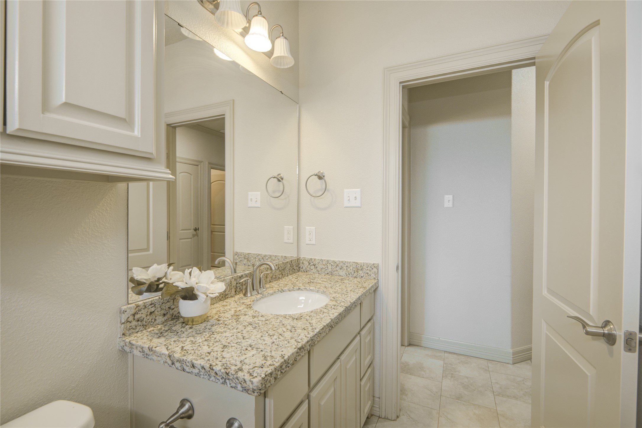 57 Red Maple Court Lake Jackson, TX 77566 - Photo 34 of 44 a bathroom with a granite countertop sink and a mirror
