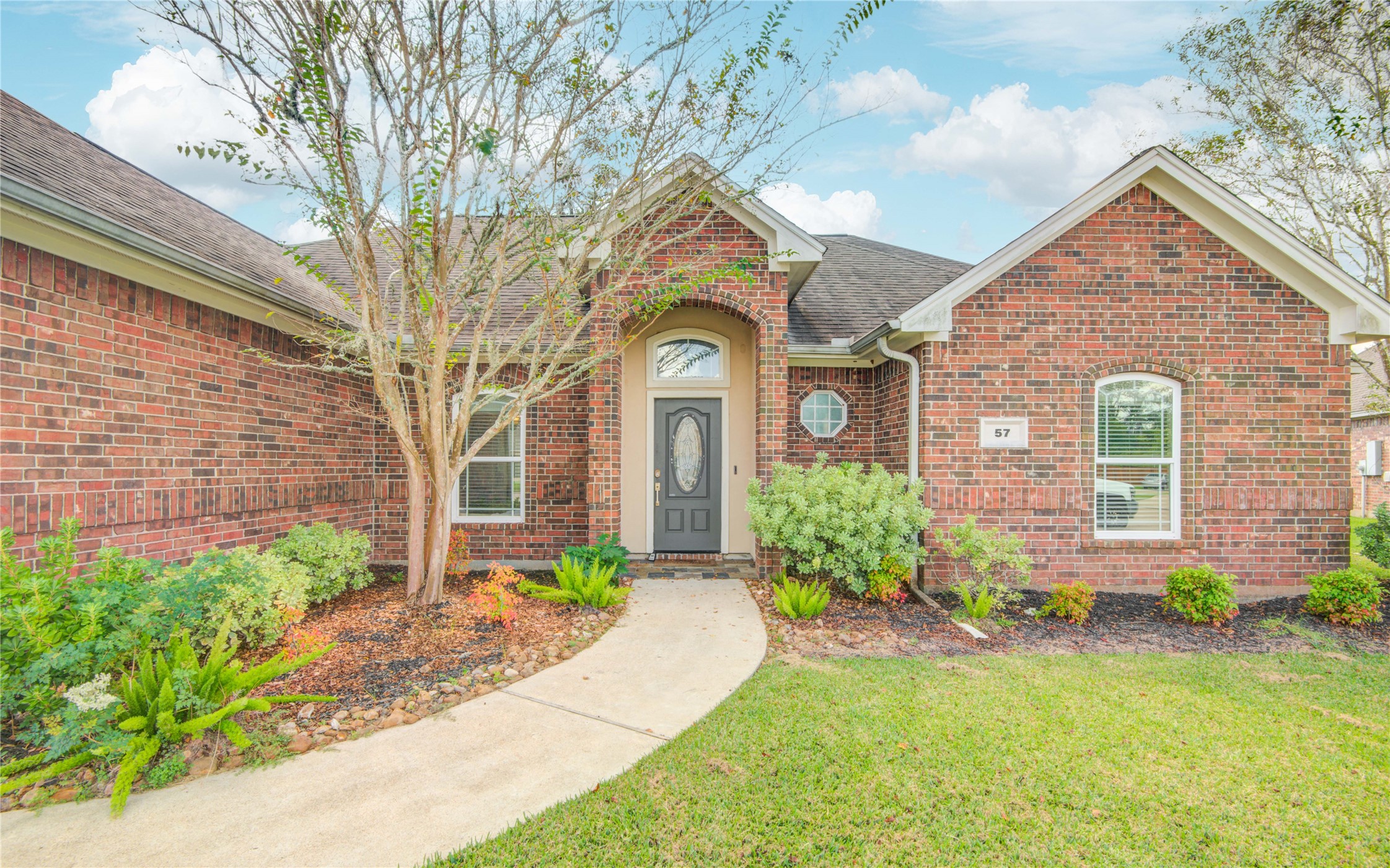 57 Red Maple Court Lake Jackson, TX 77566 - Photo 4 of 44 a front view of a house with garden