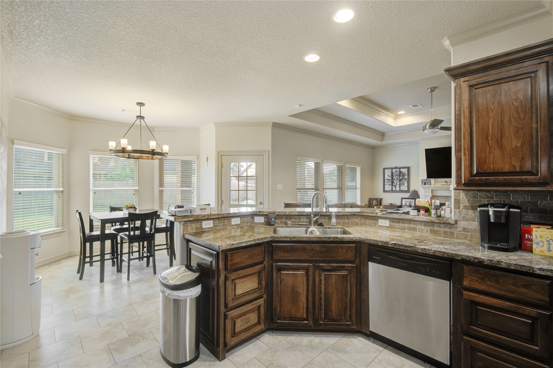 57 Red Maple Court Lake Jackson, TX 77566 - Photo 9 of 44 a kitchen with lots of counter top space sink dining table and chairs