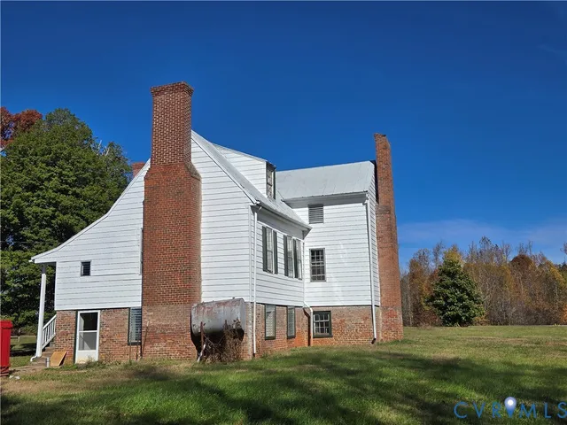 a front view of a house with a garden and yard