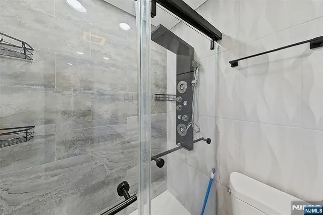 a bathroom with a shower and a toilet