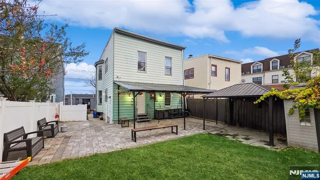 a view of a house with a yard and sitting area